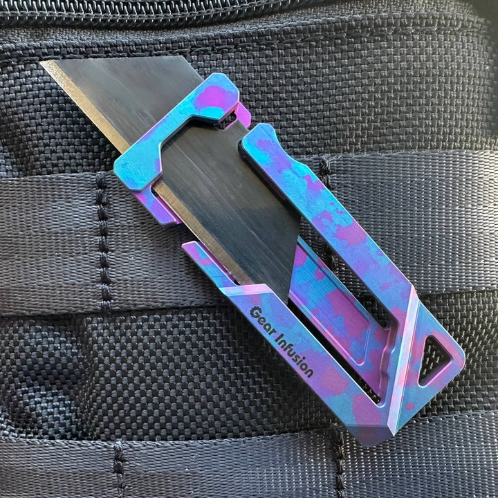 Triple anodized titanium multi-tool with unique purple and blue camo design, featuring a handcrafted layered finish, precision anodizing, and collector’s edition quality.