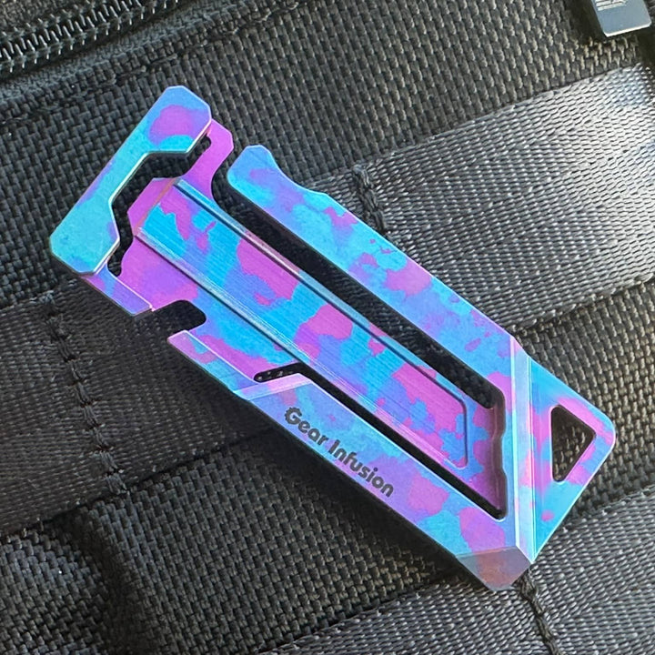 Triple anodized titanium multi-tool with unique purple and blue camo design, featuring a handcrafted layered finish, precision anodizing, and collector’s edition quality.