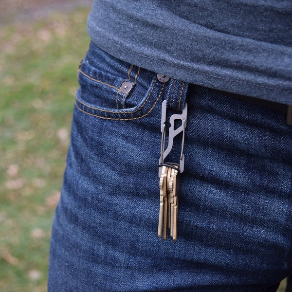 KT5 Key Titan Carabiner made from Grade 5 titanium, featuring a key organizer for up to 5 keys, built-in bottle opener, 1/4-inch slip wrench, and suppression ring for silent key carry.